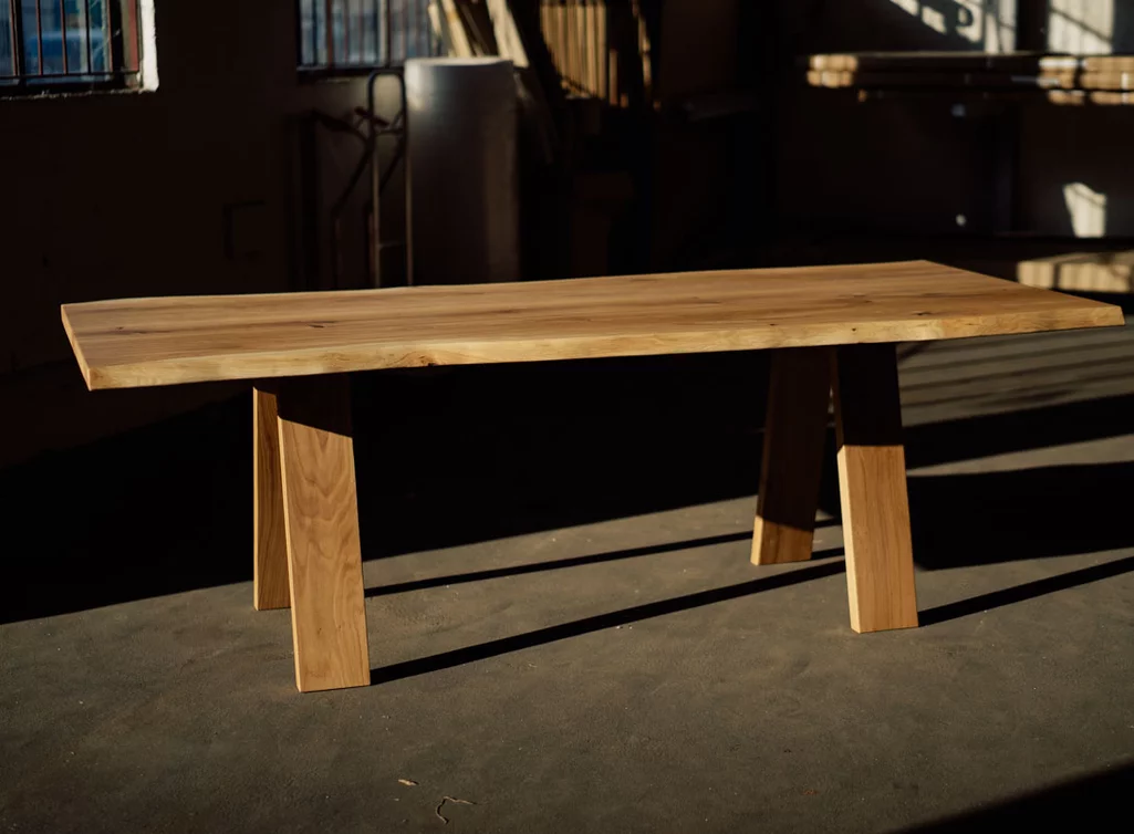 Baumtisch aus massiver Eiche mit Astanteil und Baumkanten gefertigt.